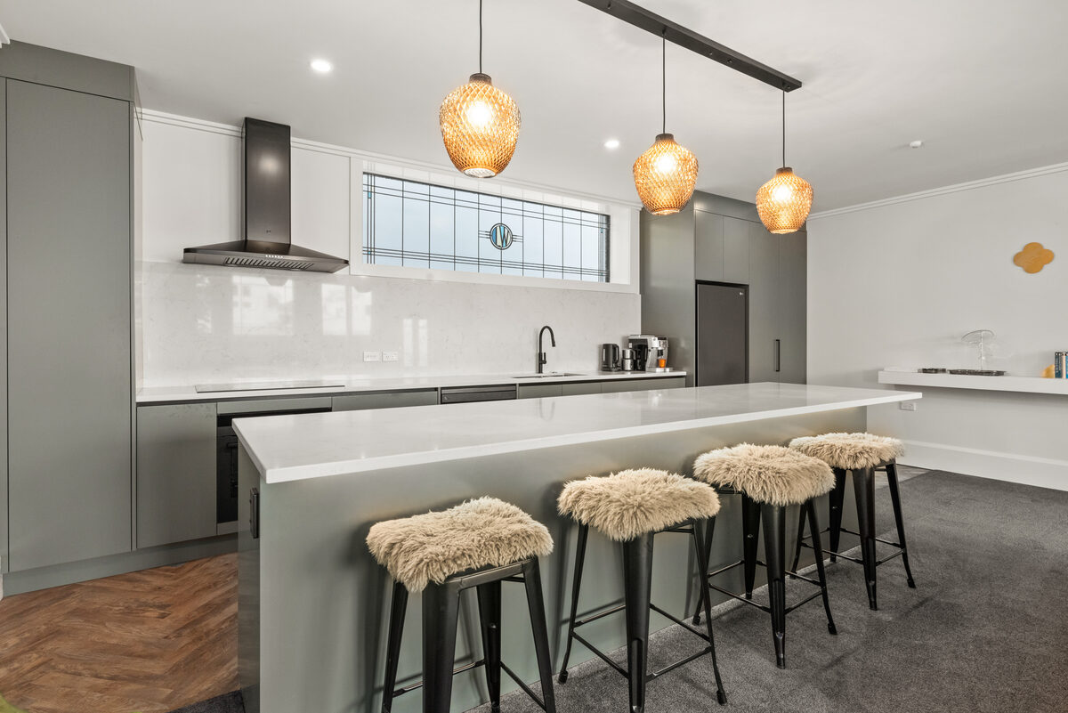 Designer kitchen with island bench — furnished apartment Napier